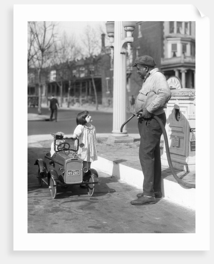 1920s Little Girl Standing Beside Her Pedal Car Asking For Gasoline by Anonymous