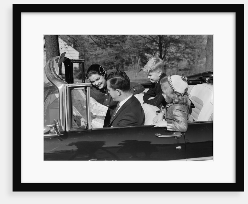 1950s Family Father Mother Daughter Son In Convertible Reading Map by Anonymous