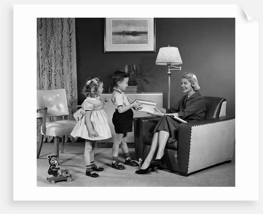 1950s Little Boy And Girl Son And Daughter Giving Woman Mother Sitting In Living Room A Gift Present by Anonymous
