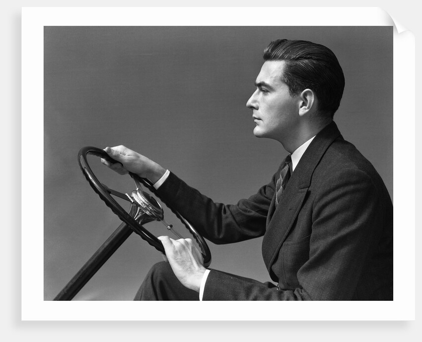 1930s 1940s Man Wearing Suit And Tie Holding Automobile Steering Wheel by Anonymous