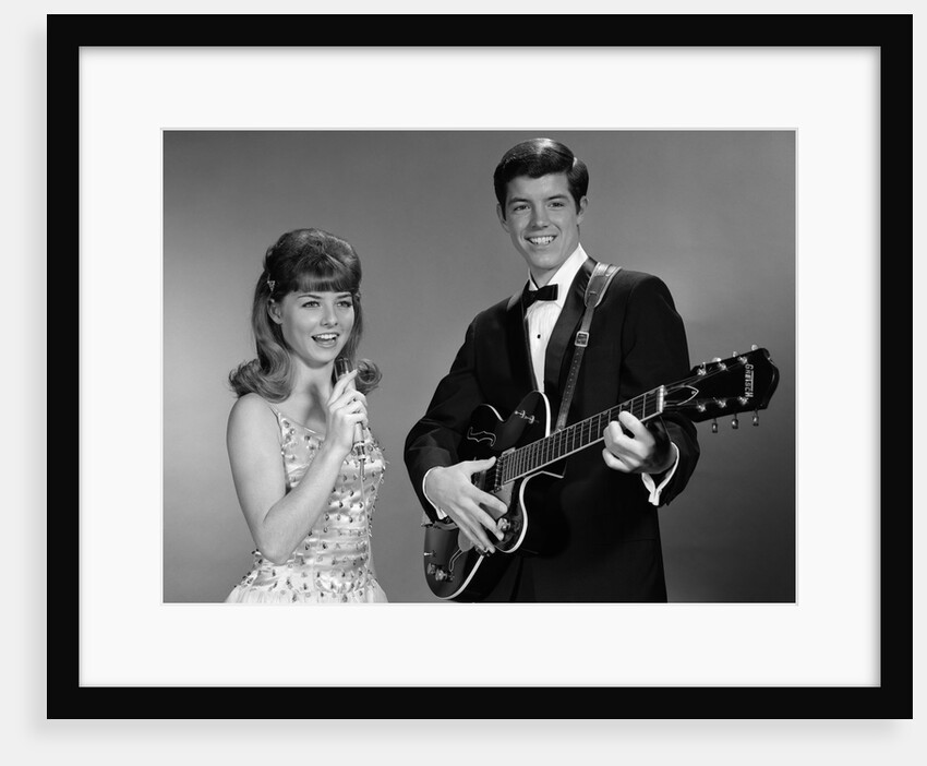1960s Teenage Entertainment Duo Man Playing Guitar And Woman Singing Holding Microphone by Anonymous