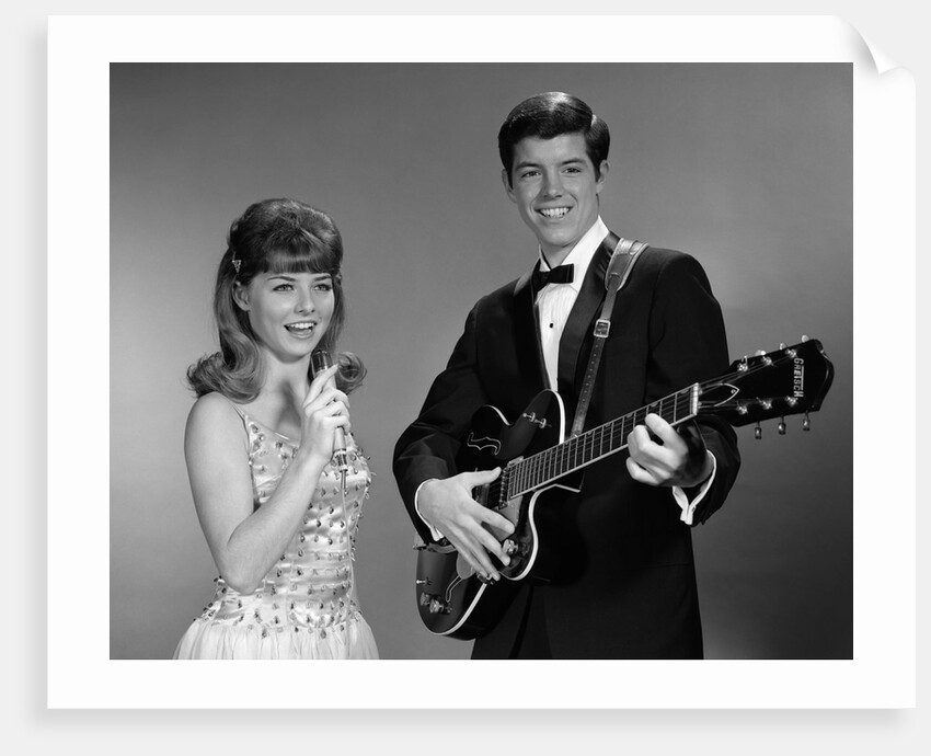 1960s Teenage Entertainment Duo Man Playing Guitar And Woman Singing Holding Microphone by Anonymous