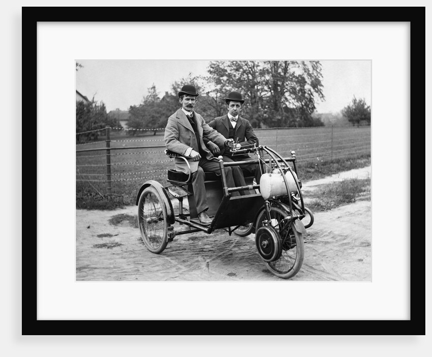 1900s Two Men In Bowler Hats Sitting In Three Wheel Motorized Horseless Carriage by Anonymous