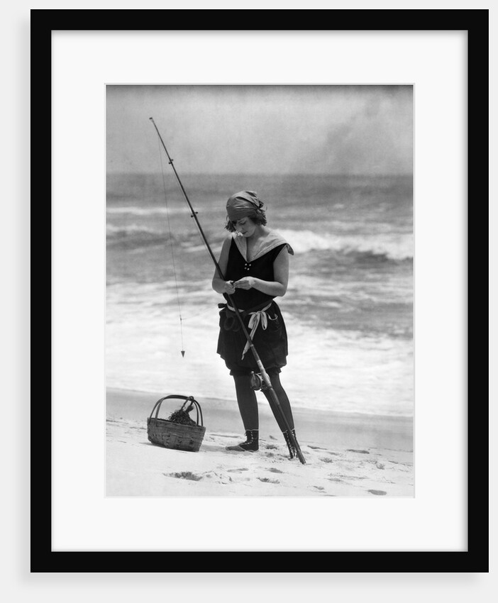 1920s Woman In Bathing Suit Costume Standing On Beach Putting Bait On Surf Fishing Pole by Anonymous