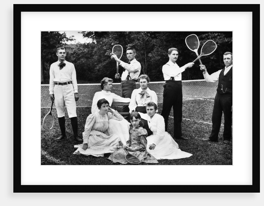 1890s 1900 Men Holding Racquets and Women and One Child In Front Of Net On Grass Tennis Court by Anonymous