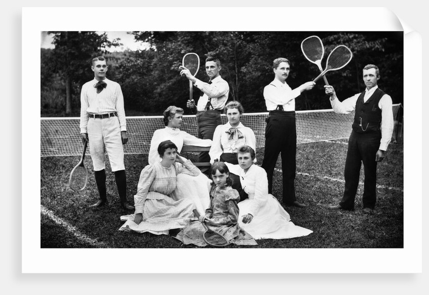 1890s 1900 Men Holding Racquets and Women and One Child In Front Of Net On Grass Tennis Court by Anonymous