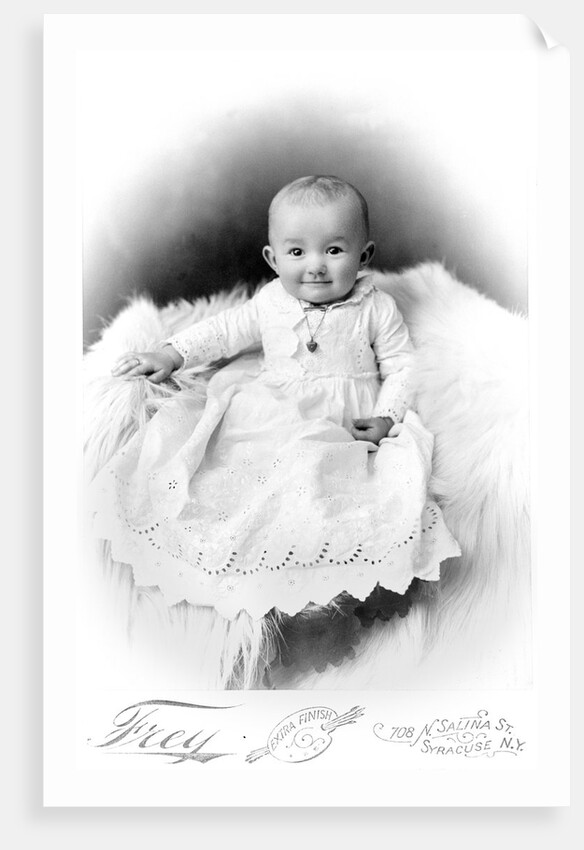 1890s 1900 Portrait Baby In Long Dress Wearing Heart Locket Sitting On White Fur Blanket by Anonymous