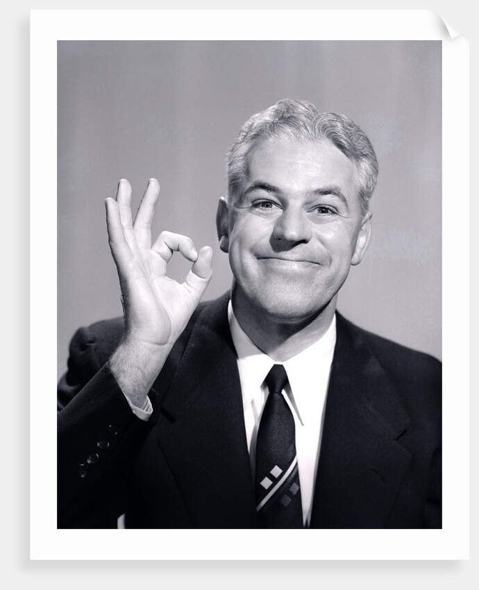 1950s Portrait Of Happy Man Businessman Slesman Making An Ok Hand Sign by Anonymous