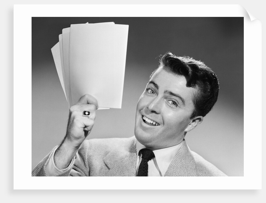 1950s Young Businessman Holding Up Handful Of Papers by Anonymous