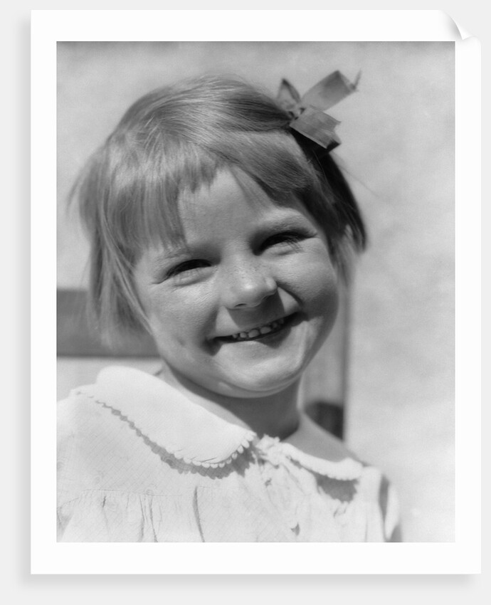 1930s Young Girl Outdoor Portrait With Freckles And Bow In Hair At Camera by Anonymous
