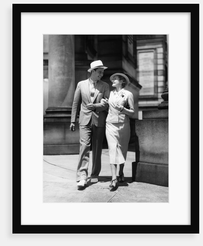 1930s Couple In Suits And Hats Walking Arm In Arm by Anonymous