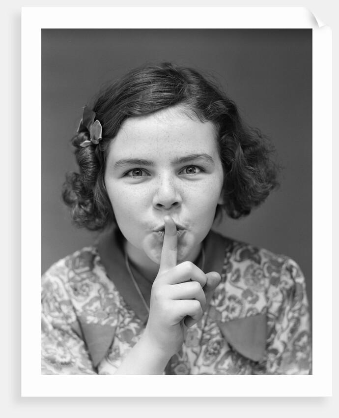 1930s Portrait Of Young Girl With Finger To Mouth Making Shush Be Quiet Expression by Anonymous