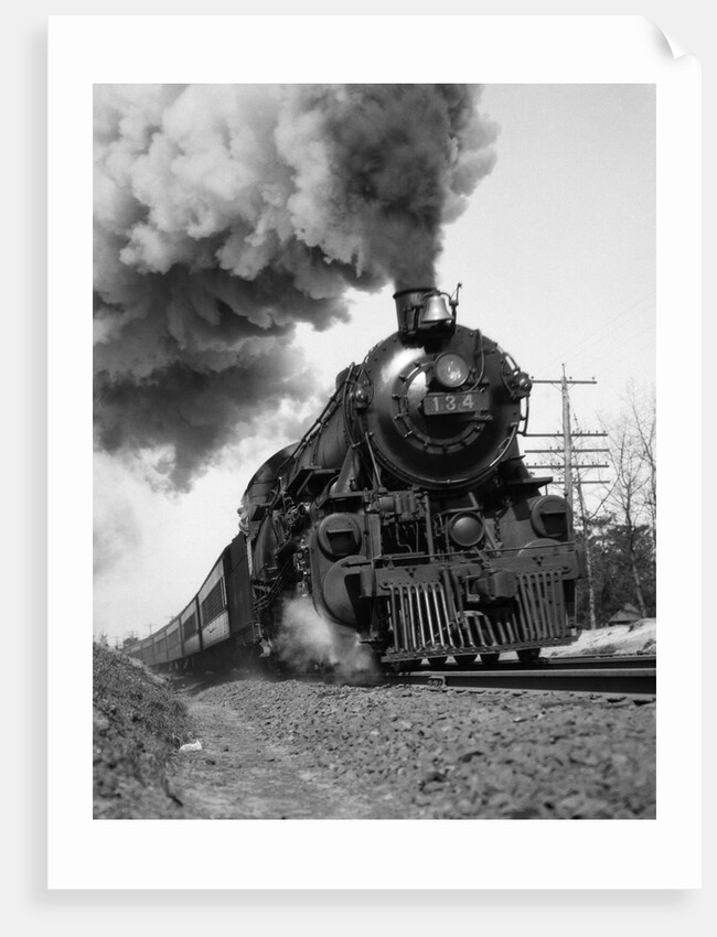 1920s 1930s Steam Engine Pulling Passenger Train Smoke Billowing From Exhaust Stack by Anonymous