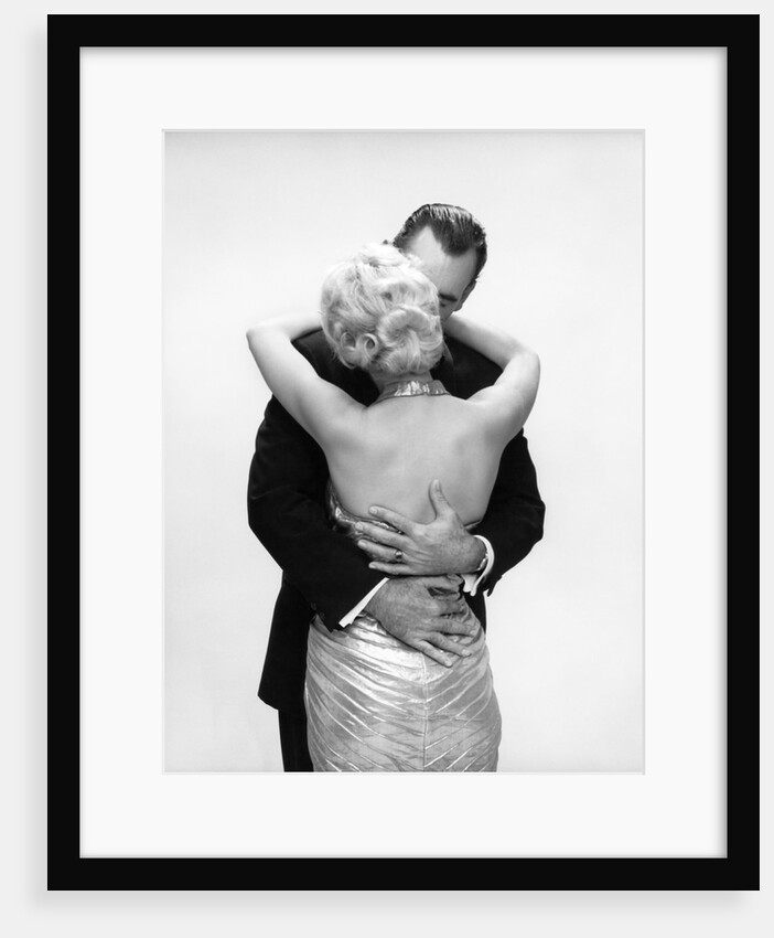 1950s 1960s Wife In Backless Satin Gown Evening Dress And Husband Embracing And Kissing by Anonymous