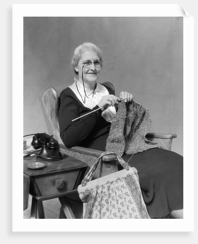 1930s Elderly Woman Wearing Pince-Nez Glasses Sitting Knitting by Anonymous