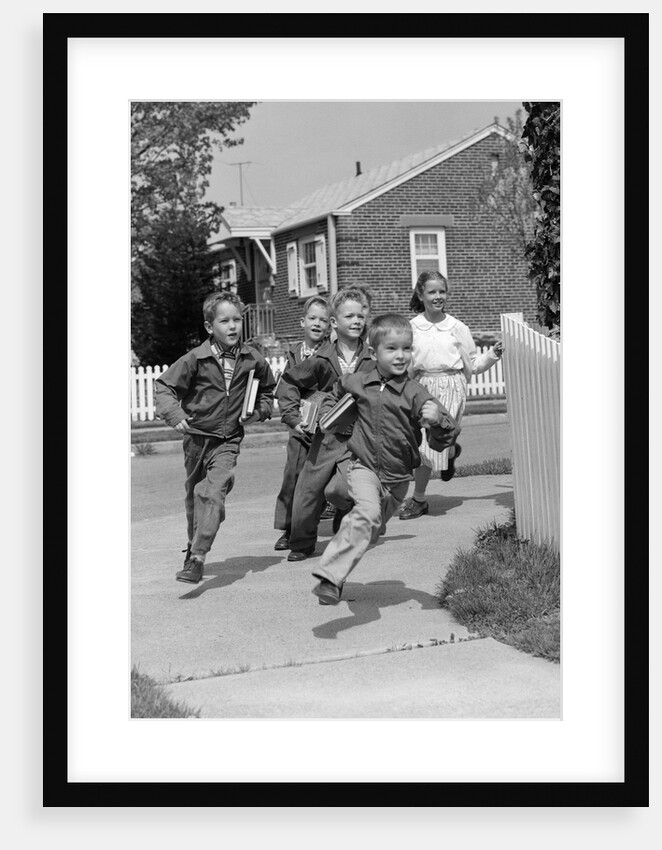 1950s School Children Running Around Corner Of Picket Fence In Suburban Neighborhood by Anonymous