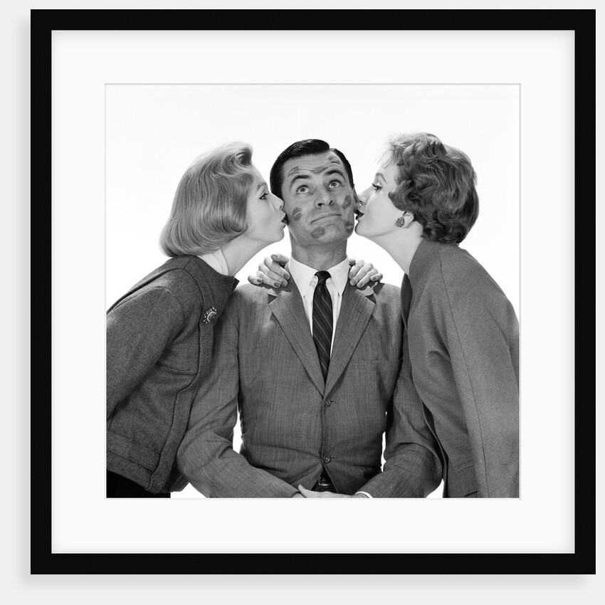1950s Two Women Kissing Single Man On Opposite Cheeks His Face Covered With Lipstick Marks by Anonymous