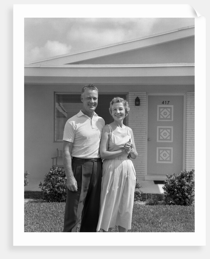1950s Older Man Woman Senior Citizen Standing Together In Retirement Home Front Yard by Anonymous
