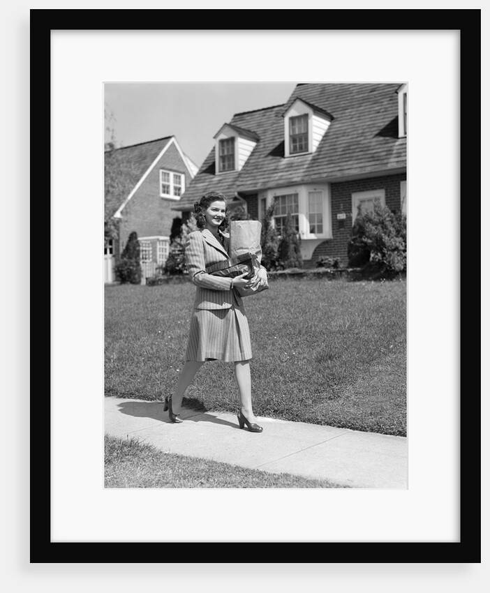 1940s Woman Walking Shopping Carrying Grocery Bag On Suburban House Sidewalk by Anonymous