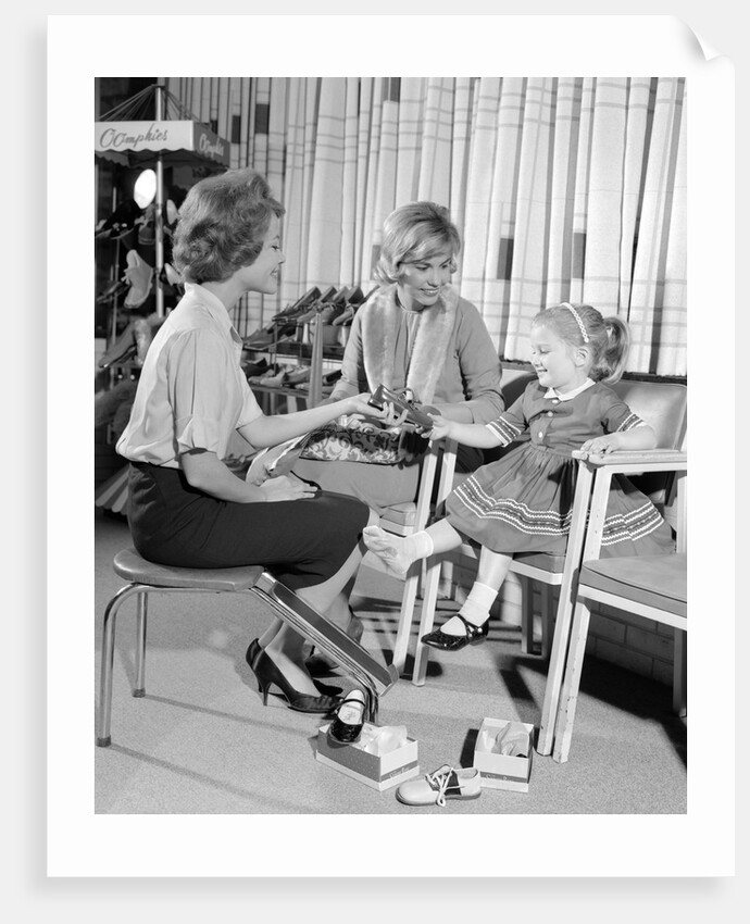 1960s Mother Daughter Shoe Shopping Saleswoman Showing Patent Leather Shoe To Girl by Anonymous