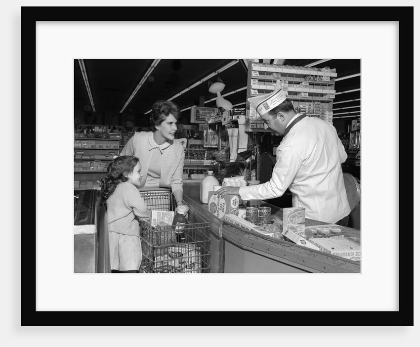 1960s Mother Daughter Unload Grocery Cart At Supermarket Checkout Counter by Anonymous