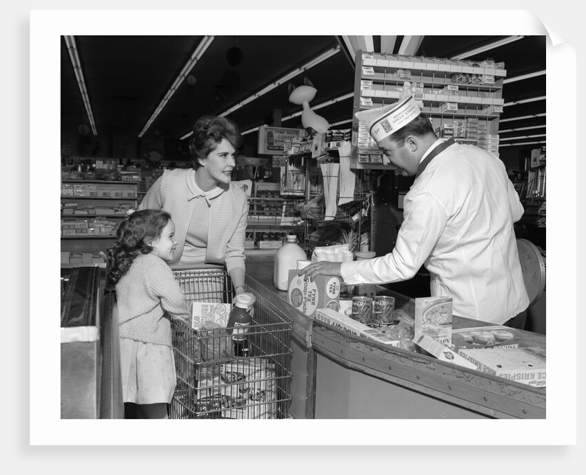 1960s Mother Daughter Unload Grocery Cart At Supermarket Checkout Counter by Anonymous