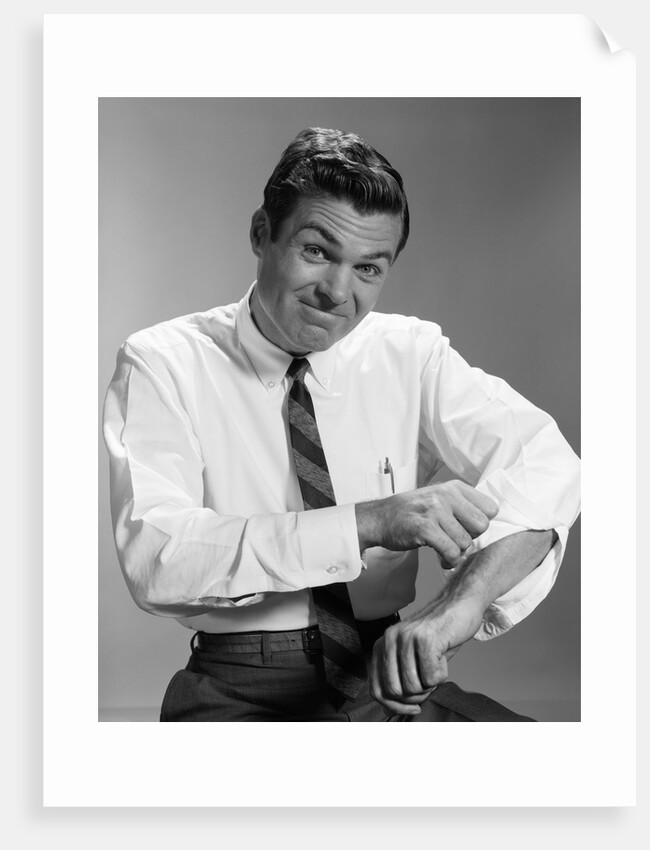 1960s Man In Business Shirt And Tie Rolling Up His Sleeves To Work Determined Look Studio by Anonymous