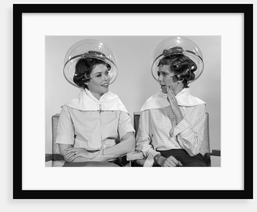 1960s Two Women Sitting Together Gossiping Under Hairdresser Hair Dryer by Anonymous