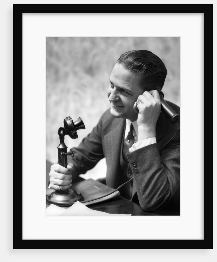 1920s Businessman Talking Into Candlestick Telephone by Anonymous