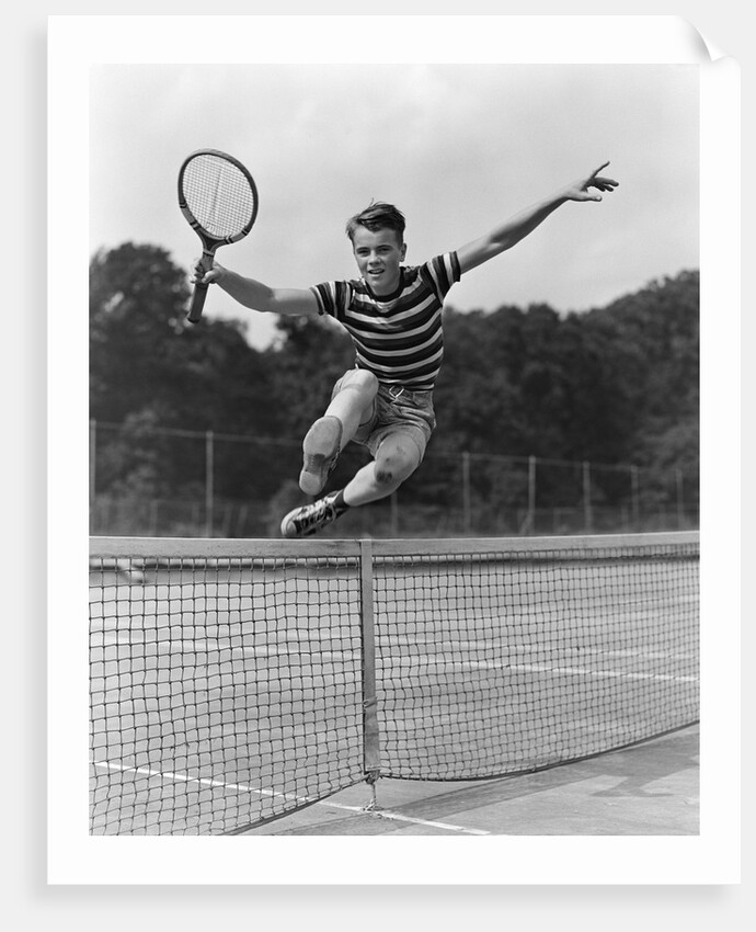 1930s Teenage Boy Tennis Player Jumping Net With Racket In Hand by Anonymous