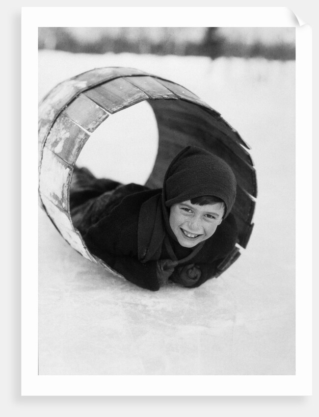 1920s Boy Playing Lying In Snow Rolling In Wooden Barrel by Anonymous
