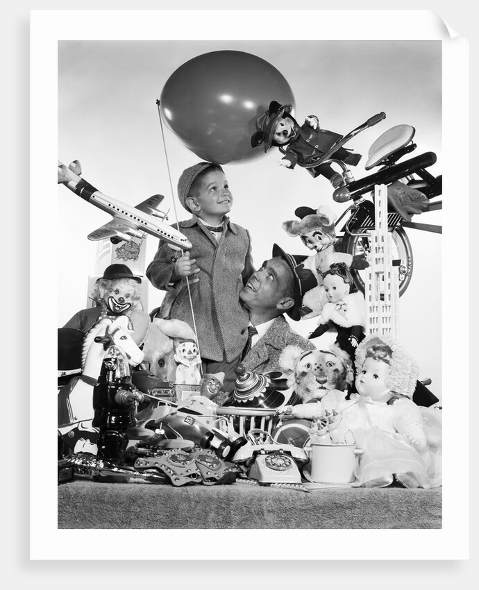 1950s Father With Son Holding Balloon Surrounded By Toys and Stuffed Animals by Anonymous