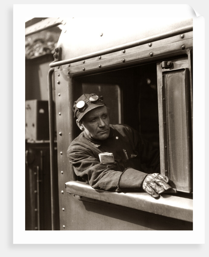 1920s 1930s 1940s Railroad Train Engineer Looking Out Window Of Locomotive Cab Driving The Steam Engine by Anonymous