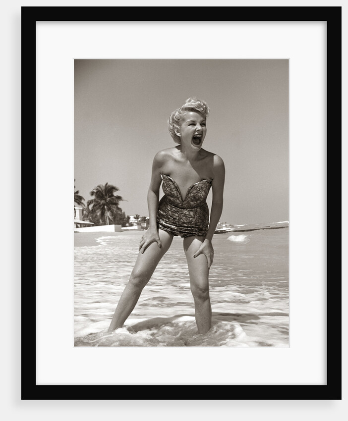 1950s Laughing Woman In Strapless Low Cut Bathing Suit Swim Wear Wading Up To Ankles In Surf by Anonymous