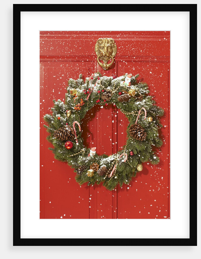 Christmas wreath hanging on a door by Anonymous