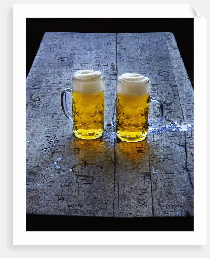 Two Glass Mugs of Beer on Table by Anonymous