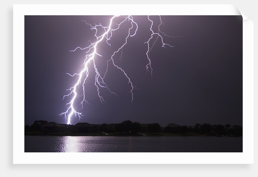Lightning Striking Ground Near Residential Lake by Anonymous