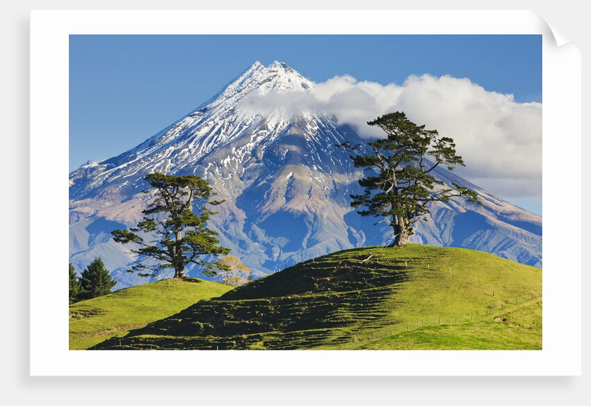 Lush hills in front of Mount Egmont by Corbis