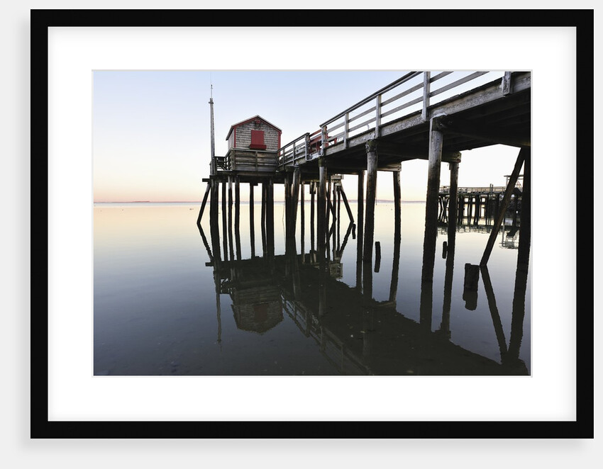 Fishing pier at low tide in a calm bay by Anonymous