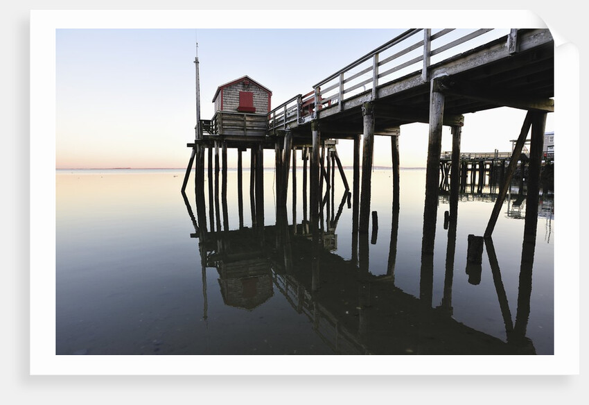 Fishing pier at low tide in a calm bay by Anonymous