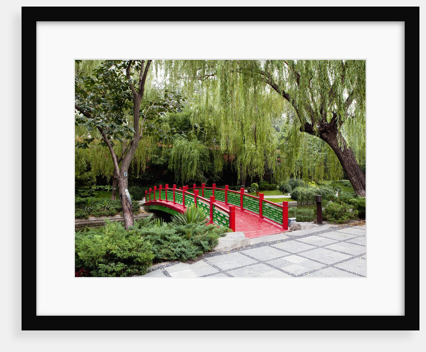Footbridge over stream in garden by Anonymous