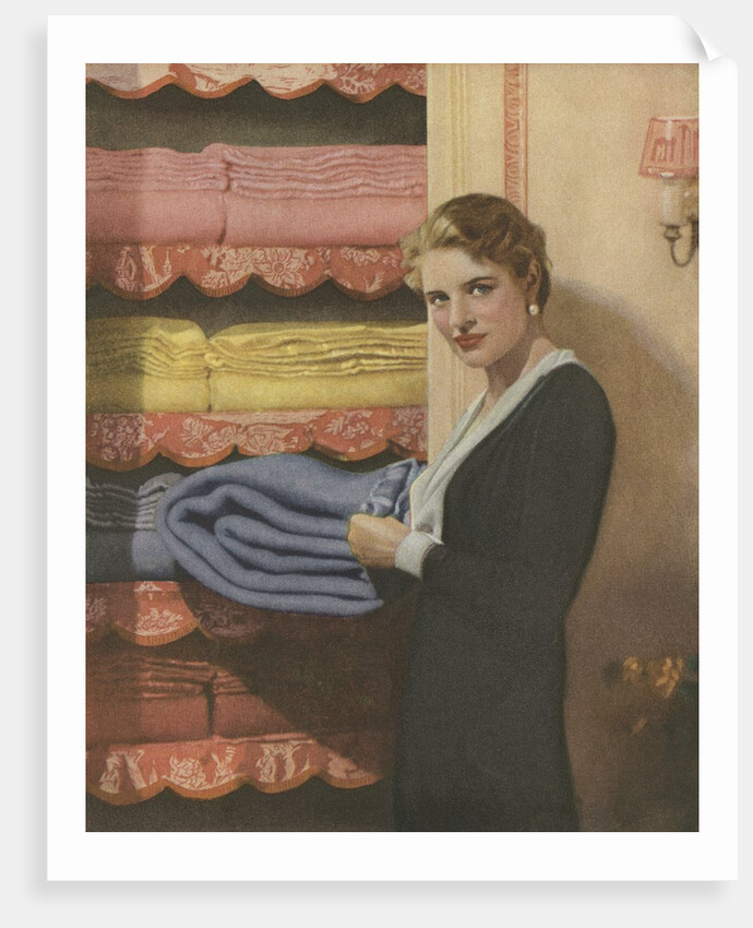 Woman puting away blanket in linen closet by Anonymous