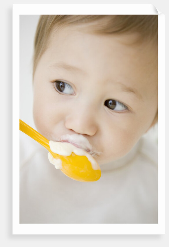 Boy having ice cream with spoon by Anonymous
