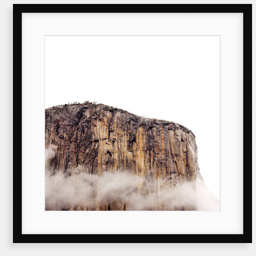 Sheer cliff rising above clouds by Anonymous