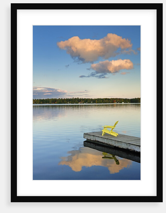 Clouds reflected in Silent Lake with Muskoka chair on dock by Anonymous