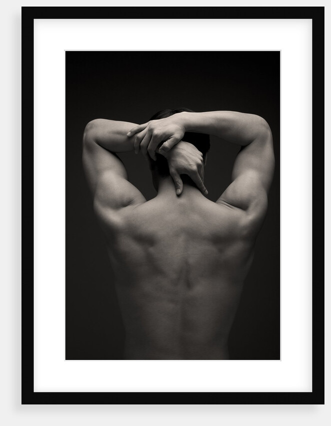 Rear view of a male stretching his arm behind his head by Anonymous