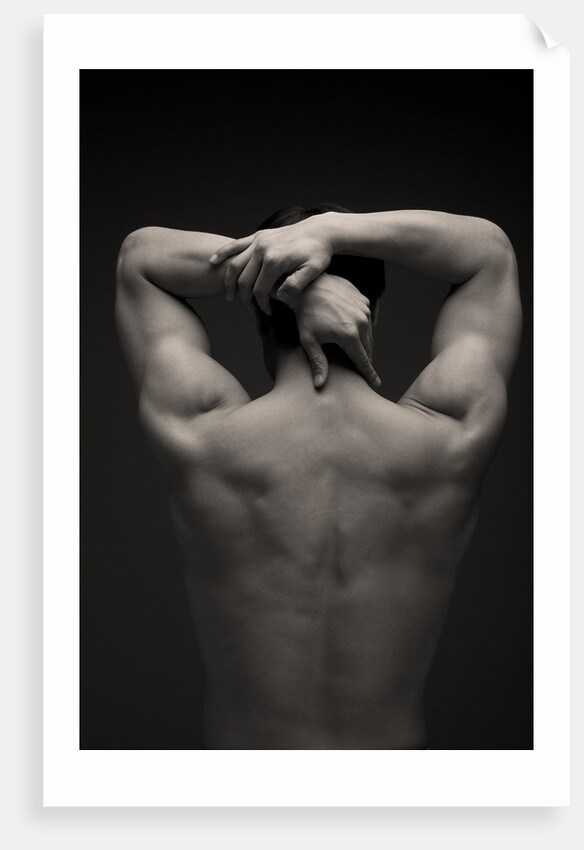 Rear view of a male stretching his arm behind his head by Anonymous