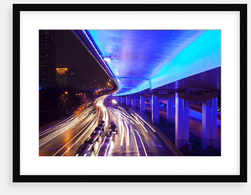 Traffic beneath neon-lit elevated road by Anonymous