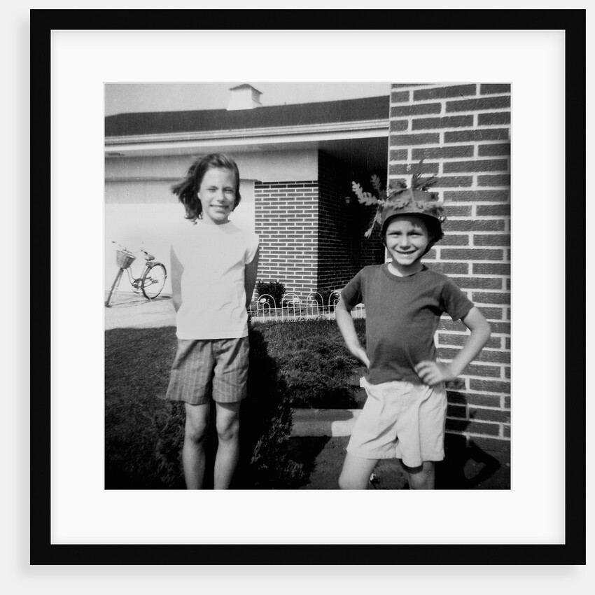 Brother and sister playing in front of their house, ca. 1965 by Anonymous