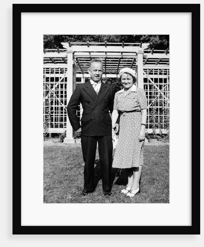 Middle aged couple pose on the lawn, ca. 1939 by Anonymous